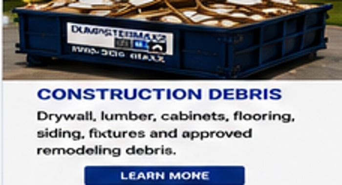 DumpsterMaxx dumpster with construction debris at or below rim